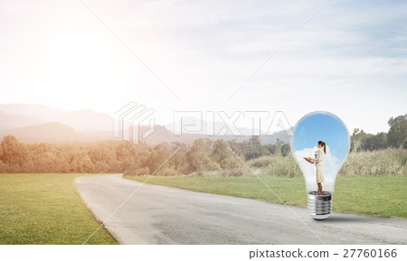 Businesswoman inside light bulb Businesswoman inside light bulb 27760166