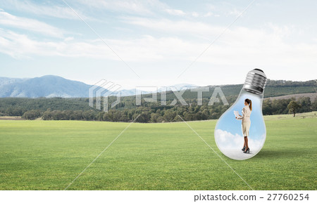 Businesswoman inside light bulb Businesswoman inside light bulb 27760254
