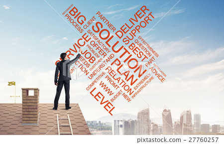 Young businessman standing on house roof and writing leadership Young businessman standing on house roof and writing leadership 27760257