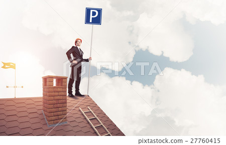 Young businessman with parking sign standing on brick roof. Mixe Young businessman with parking sign standing on brick roof. Mixe 27760415