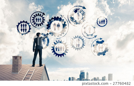 Businessman on house roof presenting teamwork and connection con 27760482