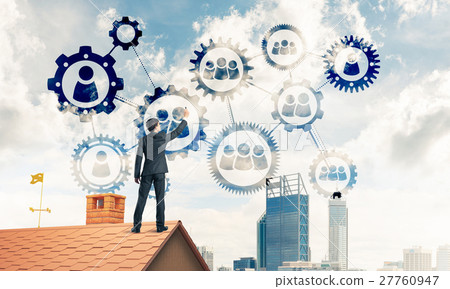 Businessman on house roof presenting teamwork and connection con 27760947