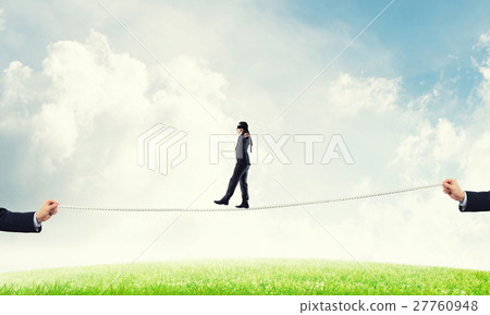 Business concept of risk support and assistance with man balancing on rope Business concept of risk support and assistance with man balancing on rope 27760948