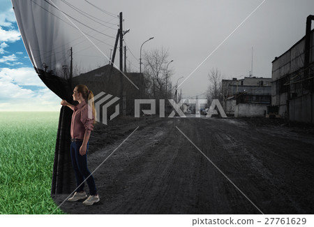 young woman pushes the curtain 27761629