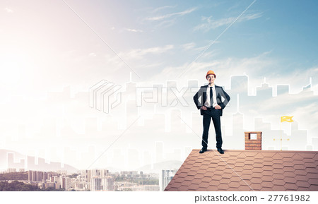 Engineer man standing on roof and looking away. Mixed media Engineer man standing on roof and looking away. Mixed media 27761982