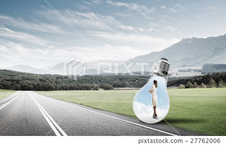 Businesswoman inside light bulb Businesswoman inside light bulb 27762006
