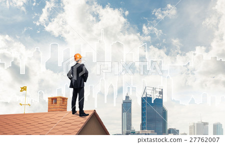 Engineer man standing on roof and looking away. Mixed media Engineer man standing on roof and looking away. Mixed media 27762007