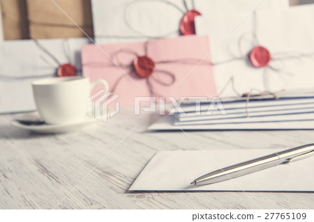 Letters with seal on table 27765109