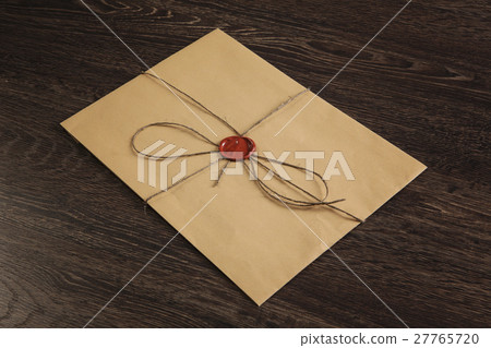 Letter with seal on table 27765720