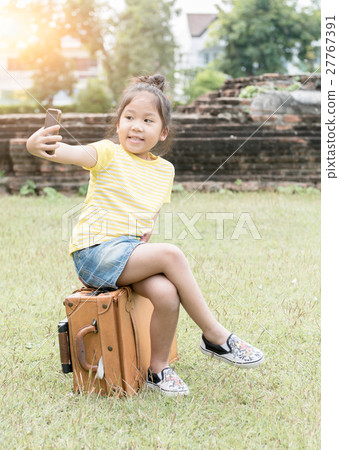 Cute girl taking a selfie with smart phone Cute girl taking a selfie with smart phone 27767391