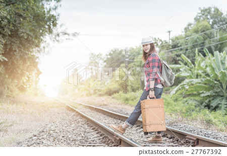 Hipster young girl with backpack walk on railway 27767392