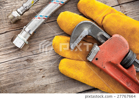 Set of plumbing and tools on the wooden table 27767664