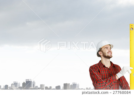 Builder checking spirit level 27768084