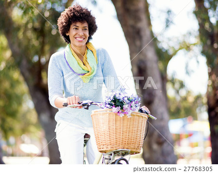 Happy young woman with bicycle Happy young woman with bicycle 27768305