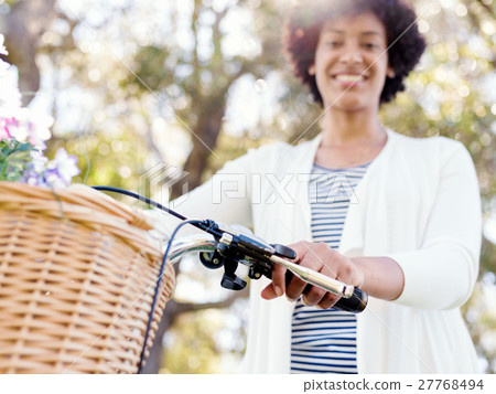 Happy young woman with bicycle 27768494