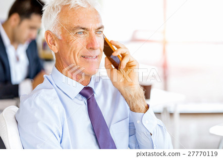 Businessman at the office with mobile phone 27770119
