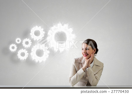 Businesswoman sitting at desk Businesswoman sitting at desk 27770430