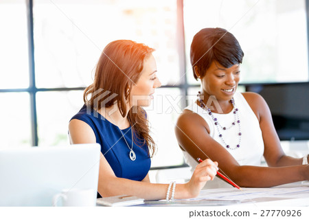 Women working together, office interior 27770926