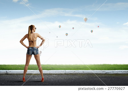 Hitch hiker woman on road 27770927