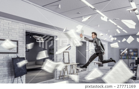 Jumping businessman in office Jumping businessman in office 27771169
