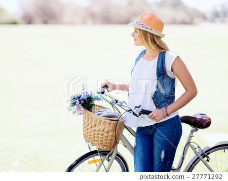 Happy young woman with bicycle Happy young woman with bicycle 27771292