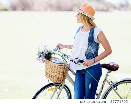 Happy young woman with bicycle Happy young woman with bicycle 27771705