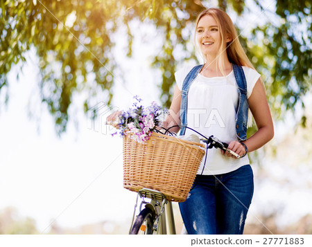Happy young woman with bicycle Happy young woman with bicycle 27771883
