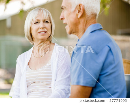 Senior couple relaxing in park Senior couple relaxing in park 27771993