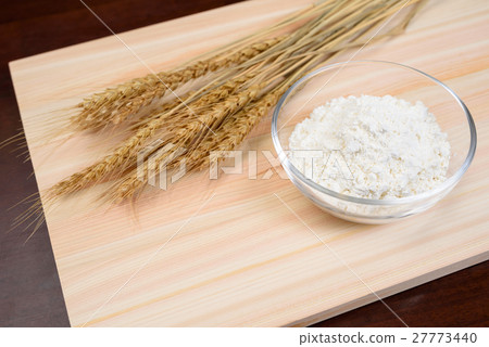 Flour and wheat in a glass bowl and chopping board Flour and wheat in a glass bowl and chopping board 27773440