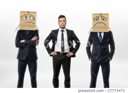 One businessman standing between two other men 27773471