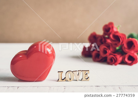 Red heart shape with word "love" and red rose 27774359