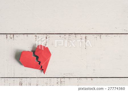 Red broken heart on white wooden background 27774360