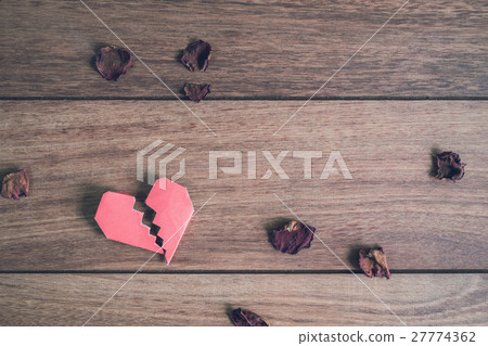 Red broken heart with dried rose petal 27774362