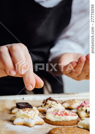 Person finishing homemade cookies Person finishing homemade cookies 27778898