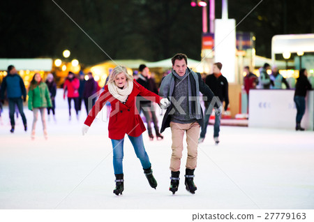 Beautiful senior couple ice skating in city centre Beautiful senior couple ice skating in city centre 27779163