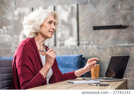 Senior woman holding pen Senior woman holding pen 27781141