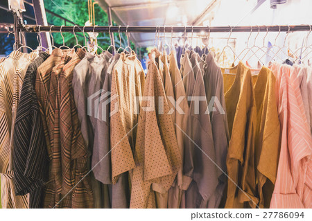Hand made cotton shirts hanging on bar Hand made cotton shirts hanging on bar 27786094