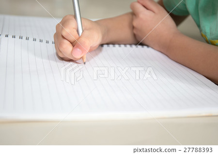 child hand writing on blank notebook by pencil child hand writing on blank notebook by pencil 27788393