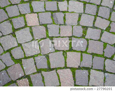 Square brick stone pattern on the street with moss 27790201