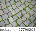 Square brick stone pattern on the streetwith moss 27790203