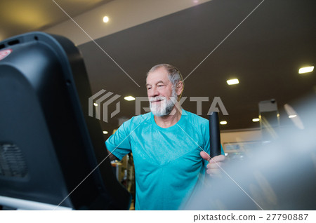Fit senior man in gym doing cardio work out. 27790887