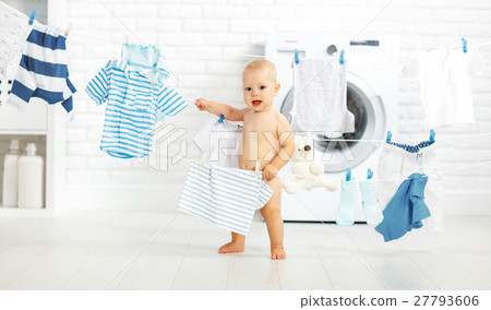 fun happy baby boy to wash clothes and laughs in laundry fun happy baby boy to wash clothes and laughs in laundry 27793606