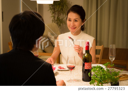 A middle-aged couple dining at a restaurant A middle-aged couple dining at a restaurant 27795323