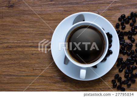 White cup of coffee on vintage wood. White cup of coffee on vintage wood. 27795834