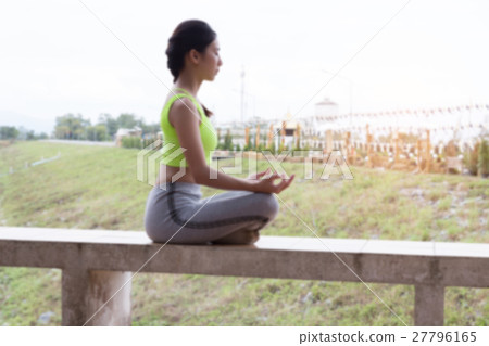 young woman meditates while practicing yoga outdoor in park, relax in nature (blur image) young woman meditates while practicing yoga outdoor in park, relax in nature (blur image) 27796165