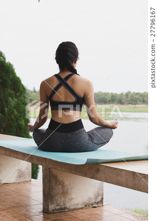 young woman meditates while practicing yoga outdoor in park, relax in nature young woman meditates while practicing yoga outdoor in park, relax in nature 27796167