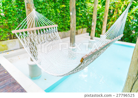 White hammocks in Luxury swimming pool . 27796525