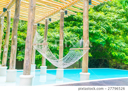 White hammocks in Luxury swimming pool . 27796526