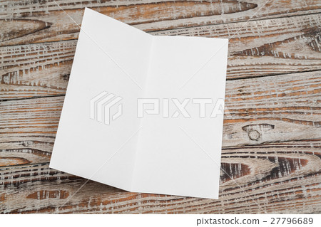 Bifold white template paper on wood texture . 27796689