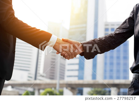 Business success hand shaking in front of building 27798257